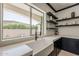 Bright kitchen with an apron sink, open shelving, and dark cabinetry at 199 E Tangerine Path, Queen Creek, AZ 85140
