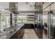 A gourmet kitchen with stainless steel appliances, a gas range, and custom cabinetry at 199 E Tangerine Path, Queen Creek, AZ 85140
