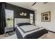 Stylish main bedroom featuring modern decor, dark accent wall, and natural light from the bedroom windows at 199 E Tangerine Path, Queen Creek, AZ 85140