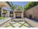 An outdoor fireplace and grill create a cozy atmosphere in the outdoor living space and entertainment area at 199 E Tangerine Path, Queen Creek, AZ 85140