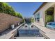 Relax in this pool with baja shelf, seating, and verdant landscaping ensuring privacy and serene enjoyment at 199 E Tangerine Path, Queen Creek, AZ 85140