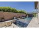 Dive into this refreshing pool with a baja shelf, hardscape, and lush landscaping providing a tranquil oasis at 199 E Tangerine Path, Queen Creek, AZ 85140