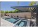 Enjoy a refreshing swim in this pool featuring a modern pergola, hardscape, and lush landscaping at 199 E Tangerine Path, Queen Creek, AZ 85140