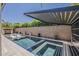 Modern pool featuring a pergola, in-pool chairs, and a unique, integrated water feature at 199 E Tangerine Path, Queen Creek, AZ 85140