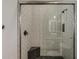 Modern shower stall featuring white vertical tiles, black shower fixtures, and a corner bench at 199 E Tangerine Path, Queen Creek, AZ 85140