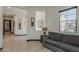 A cozy room with a sofa, decorative mirrors and wall art, and a view through an arched doorway at 199 E Tangerine Path, Queen Creek, AZ 85140