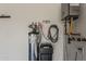 Water heater and water softener with white wall and storage accessories for plumbing or cleaning maintenance at 199 E Tangerine Path, Queen Creek, AZ 85140