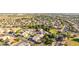 Aerial view of a quiet neighborhood with lush trees and manicured lawns, conveniently located near a main thoroughfare at 2004 N 125Th Ave, Avondale, AZ 85392