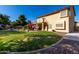 Expansive backyard featuring lush green lawn, mature trees, and a covered patio at 2004 N 125Th Ave, Avondale, AZ 85392