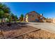 Large backyard including basketball court, lush trees, stucco exterior with a terracotta roof at 2004 N 125Th Ave, Avondale, AZ 85392