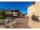 Private backyard with shaded patio seating, hot tub, grill, and desert landscaping at 2004 N 125Th Ave, Avondale, AZ 85392