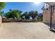 Backyard basketball court features well maintained full court with hoop, bordered by lush green trees at 2004 N 125Th Ave, Avondale, AZ 85392
