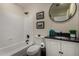 This bathroom features a tub and shower combo, plus a vanity with modern finishes at 2004 N 125Th Ave, Avondale, AZ 85392