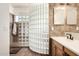 Bathroom features a glass block shower wall, tiled floors, and modern vanity at 2004 N 125Th Ave, Avondale, AZ 85392
