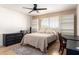 Bright bedroom featuring a ceiling fan, neutral walls, wood floors, and an area rug for a warm and inviting atmosphere at 2004 N 125Th Ave, Avondale, AZ 85392