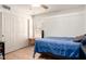 Well-lit bedroom with light wood flooring, a large closet, and a comfortable bed for relaxation at 2004 N 125Th Ave, Avondale, AZ 85392