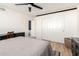 Comfortable bedroom with a ceiling fan, wood flooring, a closet, and natural light for relaxation and restful nights at 2004 N 125Th Ave, Avondale, AZ 85392