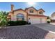 Charming two-story home featuring a two-car garage, red tile roof and desert landscaping at 2004 N 125Th Ave, Avondale, AZ 85392
