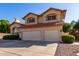 Charming two-story home featuring a two-car garage, red tile roof and desert landscaping at 2004 N 125Th Ave, Avondale, AZ 85392