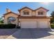 Charming two-story home featuring a two-car garage, red tile roof and a desert landscaped front yard at 2004 N 125Th Ave, Avondale, AZ 85392