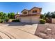 Charming two-story home featuring a two-car garage, red tile roof and desert landscaping at 2004 N 125Th Ave, Avondale, AZ 85392