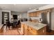 Well-equipped kitchen with wooden cabinetry, an island, stainless steel appliances, and seamless flow to the living spaces at 2004 N 125Th Ave, Avondale, AZ 85392