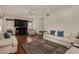 Cozy living room with a ceiling fan, hardwood floors, and modern entertainment setup at 2004 N 125Th Ave, Avondale, AZ 85392