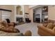 Bright living room with a fireplace, neutral carpet, and open access to other rooms at 2004 N 125Th Ave, Avondale, AZ 85392