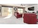Bright living room with tile floors, a ceiling fan, and a sliding glass door at 2004 N 125Th Ave, Avondale, AZ 85392