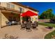 Rear view of the patio area with dining and relaxing furniture and shade at 2004 N 125Th Ave, Avondale, AZ 85392