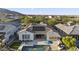 Aerial shot of a backyard featuring a pool, fire pit, outdoor seating, and solar panels on the roof at 20595 W Pasadena Ave, Buckeye, AZ 85396