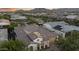 Aerial view of home with tile roof, solar panels, two-car garage, and desert landscaping at 20595 W Pasadena Ave, Buckeye, AZ 85396