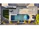 Aerial of backyard featuring pool, waterfall, fire pit, outdoor kitchen, turf, and mature desert plants at 20595 W Pasadena Ave, Buckeye, AZ 85396