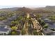 Aerial view of neighborhood showcasing lush landscaping, community spaces, and scenic mountain views at 20595 W Pasadena Ave, Buckeye, AZ 85396