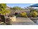 Cozy backyard featuring a stone fire pit and ample seating, ideal for outdoor gatherings by the pool at 20595 W Pasadena Ave, Buckeye, AZ 85396