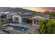 Stunning backyard with pool, fire pit, mountain views, and patio with outdoor dining set at 20595 W Pasadena Ave, Buckeye, AZ 85396