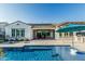 Relaxing backyard featuring a pool, covered patio, and beautiful landscaping at 20595 W Pasadena Ave, Buckeye, AZ 85396