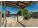 Outdoor kitchen, firepit, and dining set up in the backyard under the pergola at 20595 W Pasadena Ave, Buckeye, AZ 85396