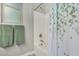 Bathroom with a white tub-shower combination and eucalyptus-themed shower curtain at 20595 W Pasadena Ave, Buckeye, AZ 85396