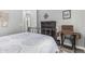 Bedroom showcasing a decorative antique sewing machine table next to a wrought iron bed at 20595 W Pasadena Ave, Buckeye, AZ 85396