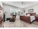 Bedroom features wood-style floors, plantation shutters, and a chaise lounge at 20595 W Pasadena Ave, Buckeye, AZ 85396