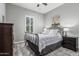 Cozy bedroom with a wrought iron bed frame, decorative rug, and window shutters at 20595 W Pasadena Ave, Buckeye, AZ 85396
