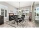 Elegant dining room featuring wood floors, plantation shutters, and modern chandelier at 20595 W Pasadena Ave, Buckeye, AZ 85396