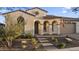 Attractive home showcasing a tile roof, an arched entryway, and a beautifully landscaped front yard at 20595 W Pasadena Ave, Buckeye, AZ 85396