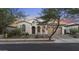 Beautiful home with an arched entryway, two-car garage, and neat front yard desert landscape at 20595 W Pasadena Ave, Buckeye, AZ 85396