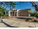 Inviting home featuring arched entryway, well-kept front yard, and a two-car garage at 20595 W Pasadena Ave, Buckeye, AZ 85396