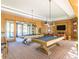 Bright game room featuring pool tables, comfortable seating, and multiple televisions at 20595 W Pasadena Ave, Buckeye, AZ 85396