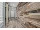 Hallway with rustic wood wall, modern lighting and wood-style tile floors at 20595 W Pasadena Ave, Buckeye, AZ 85396