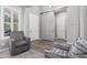 Hallway with sliding barn door and modern gray color palette at 20595 W Pasadena Ave, Buckeye, AZ 85396
