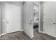 Hallway with sliding door reveals a glimpse of the primary bedroom at 20595 W Pasadena Ave, Buckeye, AZ 85396